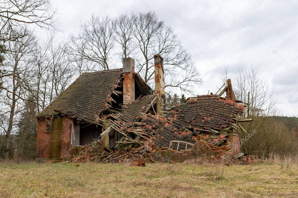 Ruins of an old red brick single family house. Demolished countr