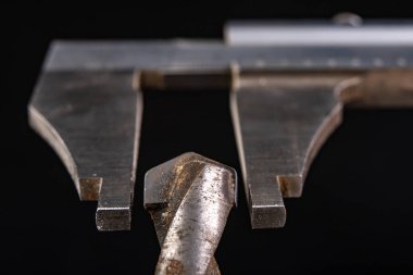 Delme çapı ile kalibreli ölçü. Marangozluk endüstrisindeki aksesuarları ölçüyorum. Koyu arkaplan.