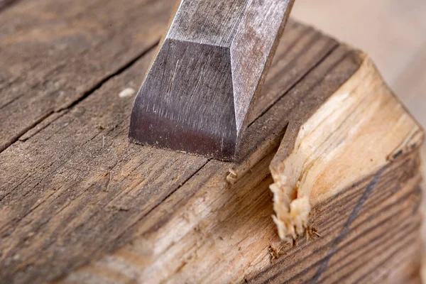 Chisel work in wood and raw wood shavings. Tools and accessories in a carpentry shop. Workplace carpentry workshop.