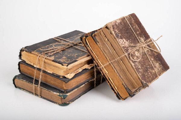 Old books bound with jute twine. Old publications prepared for archiving. Light background.