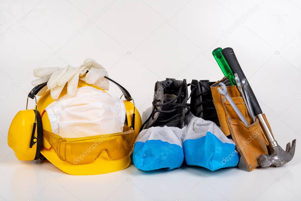 Protective clothing for builders. Virus protection during pandemic times. Light background.