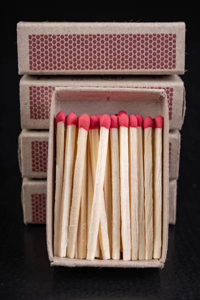 Matches for resurrecting fire in gray boxes. Old methods of lighting a fire. Dark background. — Stock Image Matches Resurrecting Fire Gray Boxes Old Methods Lighting Fire Dark Royalty Free Stock Photos