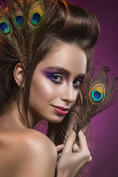 Portrait of the young girl with a vanguard hairstyle and the shine make-up in yellow-blue tones on a blue background — Stock Photo, Image