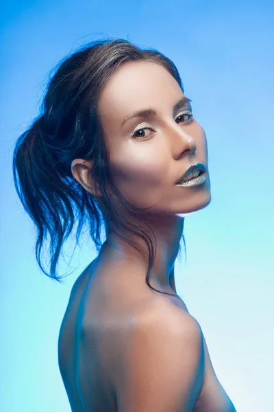 Beautiful tanned mixed asian-caucasian girl with silvery make-up