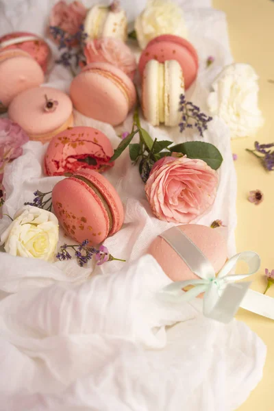 Pink and white macaroons cakes with big and small flower buds ar