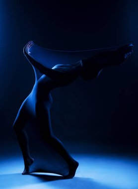 Beyaz bir beden giyen zayıf kız modern bir avangard dansı yapıyor.