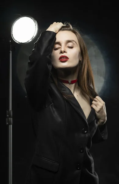 Beautiful slim girl model with red lips, wearing a black blazer, — Stock Photo, Image