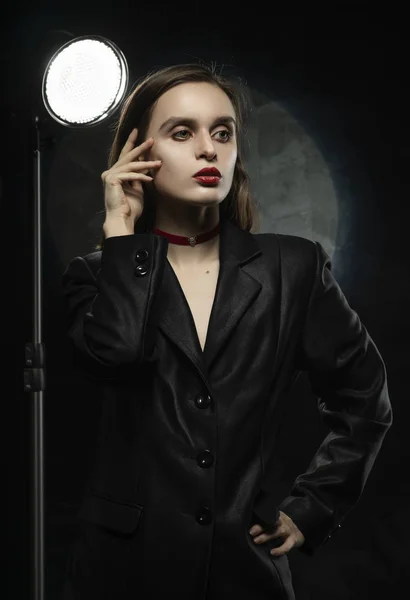 Beautiful slim girl model with red lips, wearing a black blazer, — Stock Photo, Image