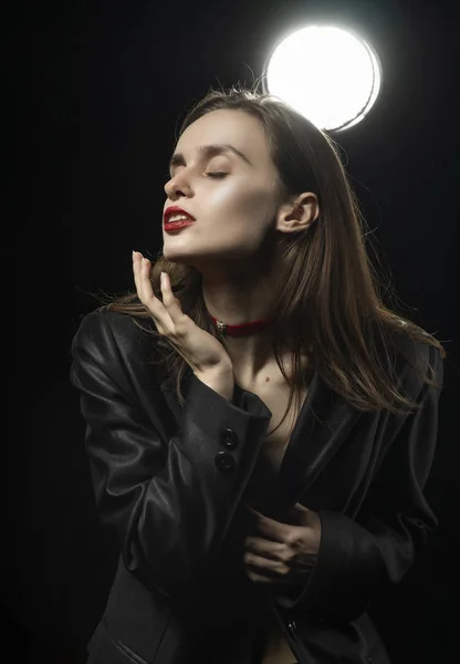 Beautiful braless girl with red lips, wearing an unbuttoned blac — 스톡 사진