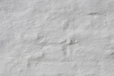 Bir tuğla duvar sıva ile kaplı kabartma dokusu