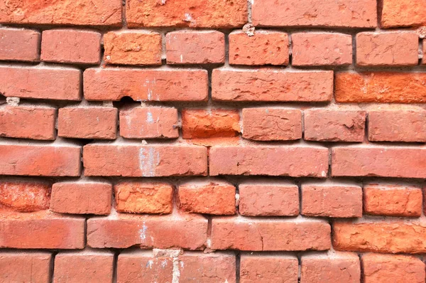 Wall from an old chipped red brick without cement — Stock Photo, Image