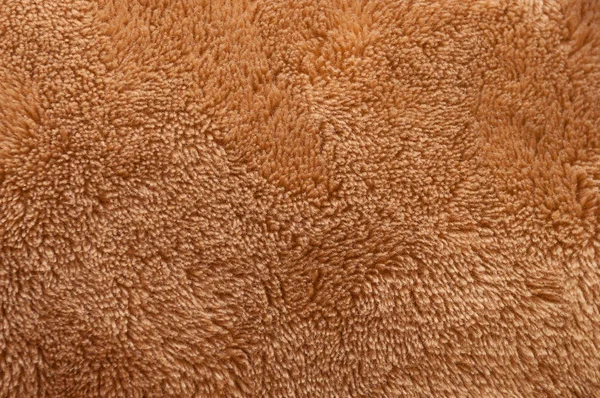 Textura de tecido macio macio macio de pelúcia marrom consistindo de muitos fios closeup — Fotografia de Stock