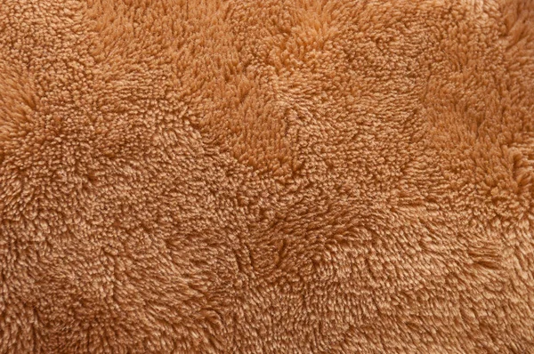 Kahverengi tüylü yumuşak peluş kumaş birçok konu closeup oluşan doku