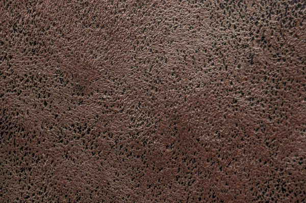 Текстура темно-коричневої м'якої замші з чорними плямами шкіри крупним планом — стокове фото