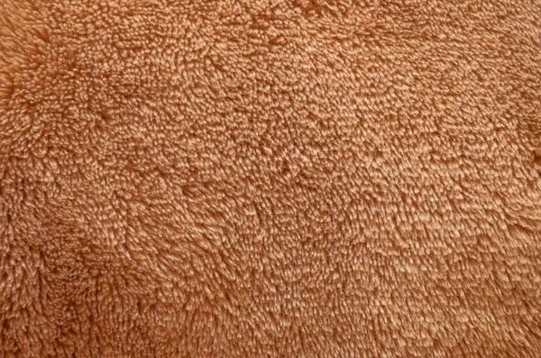 Texture of brown fluffy soft plush fabric consisting of many threads closeup — Stock Photo, Image