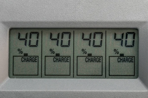 Liquid crystal display charger for batteries with charge number in percent closeup