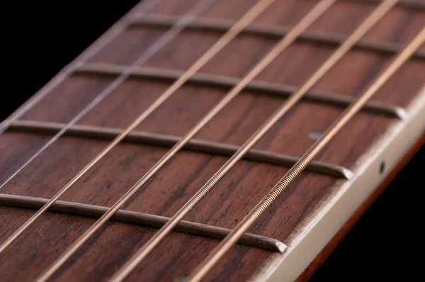 A piece of fretboard with frets and six strings of classical acoustic guitar — Stock Photo, Image