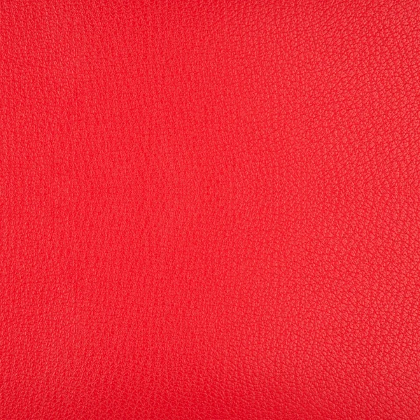 Um pedaço de couro artificial vermelho brilhante textura close-up — Fotografia de Stock