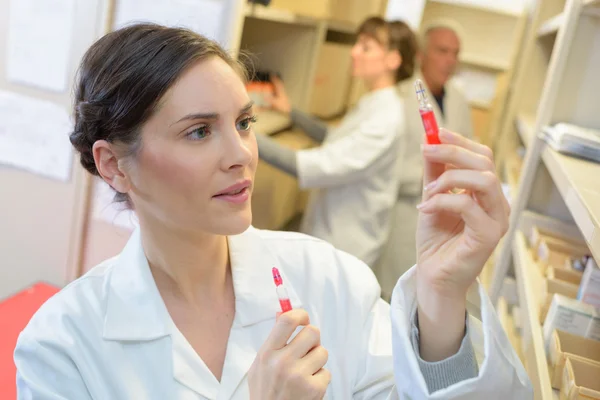 Inspecting a vial and medicine — Stock Photo, Image