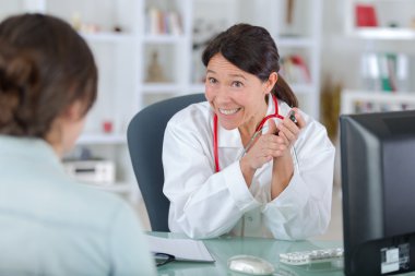 doctor talking to woman patient  clipart