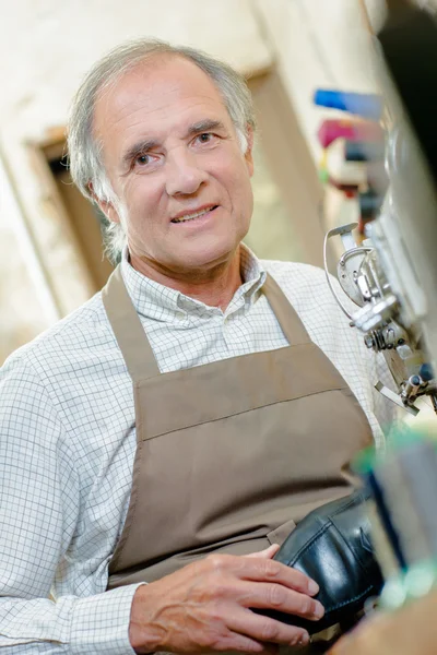 Elderly man in apron — Stock Photo, Image