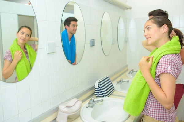 Man and woman looking at the mirror — Stock Photo, Image