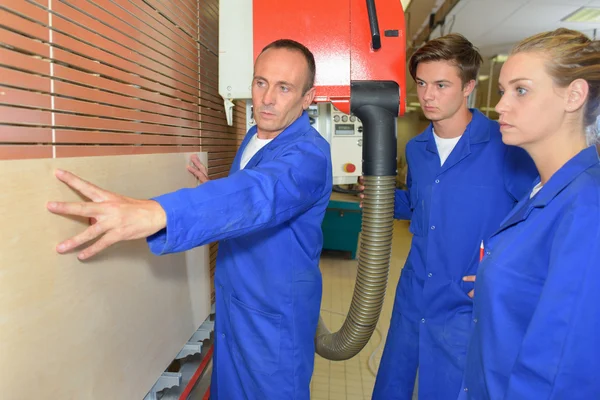 Professor laat zien hoe aan een muur — Stockfoto