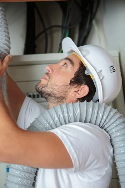 Worker putting ventilation pipes — Stock Photo, Image