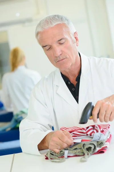 Man scanning garment and man — Stock Photo, Image