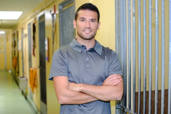 Portrait of man next to barred door — Stock Photo, Image