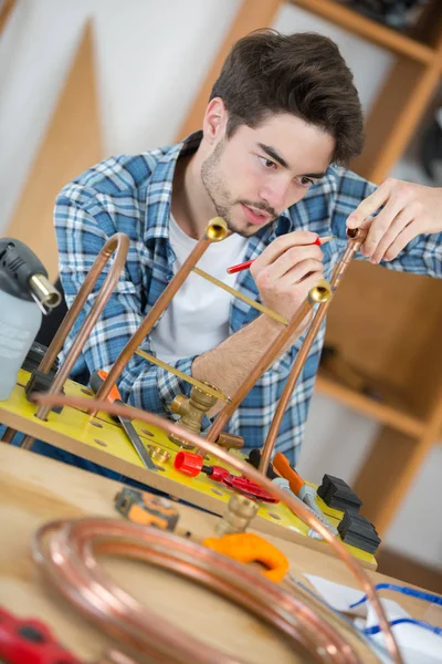 Carpenter working on his craft in a dusty workshop — Stock Photo, Image