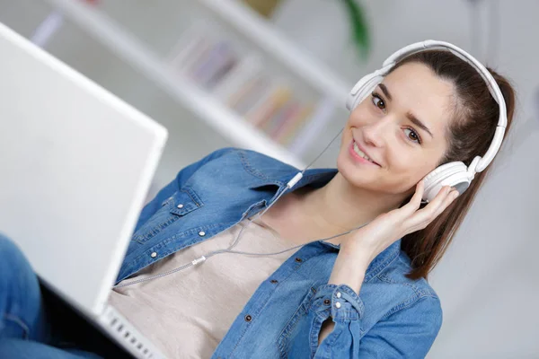 Vrouw luisteren naar muziek op haar laptop — Stockfoto