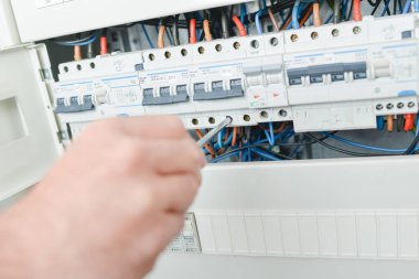 Electrician repairing a fuse clipart