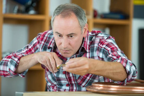 Close up portrait of a middle-age watchmaker at work — Stock Photo, Image
