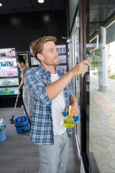 Handsome window cleaner and window — Stock Photo, Image