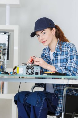 woman fixing a computer at work clipart