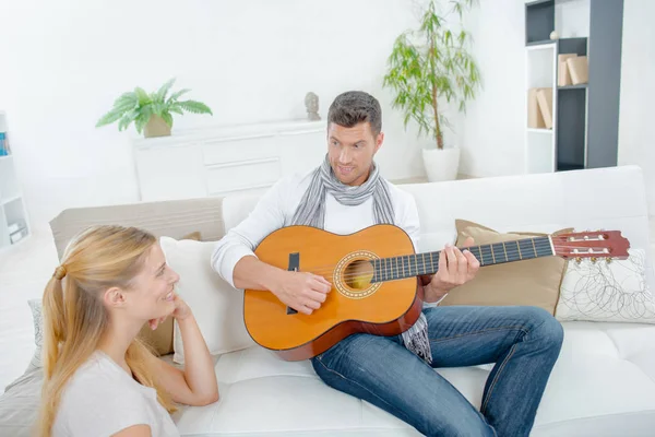 Homem tocando guitarra para senhora — Fotografia de Stock