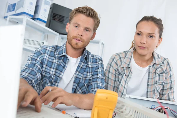 couple checking computer at home