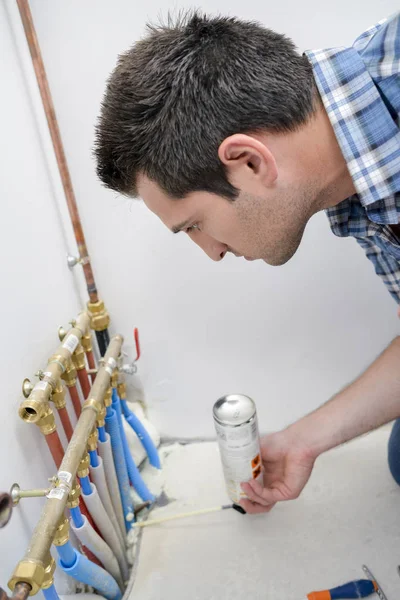 Plumber checking piping system — Stock Photo, Image