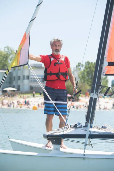 Professional waterman training on lake with catamaran — Stock Photo, Image