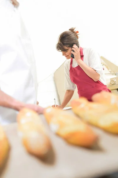 Baker with phone and apron — Stock Photo, Image