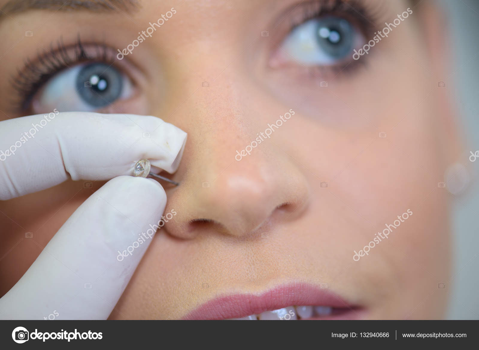 Girl getting a piercing — Stock Photo © photography33 132940666