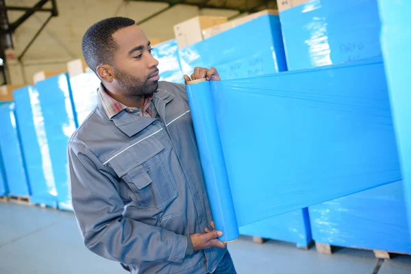 Man wrapping the container — Stock Photo, Image