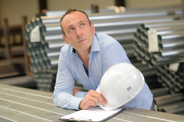 Man with hardhat looking pensive — Stock Photo, Image