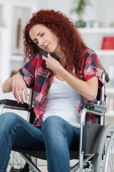 Cheerful disabled redhead woman talking on cell phone — Stock Photo, Image