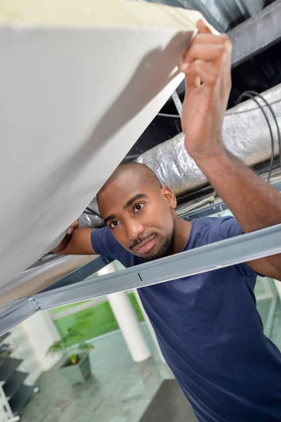 Lifting up a ceiling panel — Stock Photo, Image