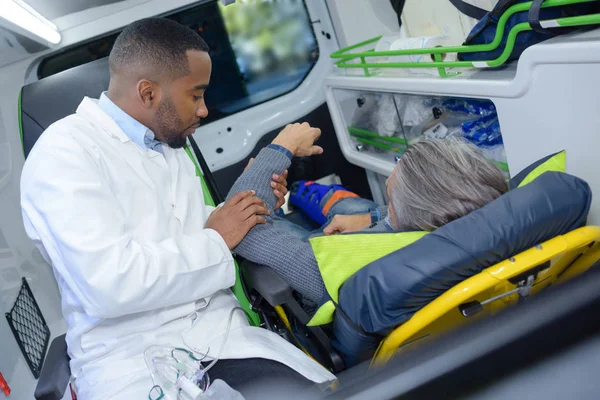 Brazo paramédico de retención del hombre en ambulancia —  Fotos de Stock