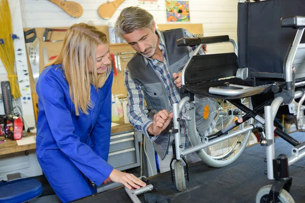 Mężczyzna i Kobieta, montaż wózka inwalidzkiego — Zdjęcie stockowe