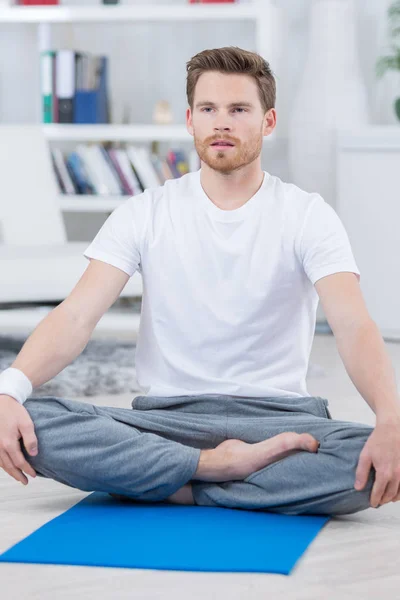 Barefoot handsome man in yoga lotus position — Stock Photo, Image