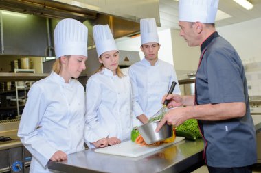 Cooking lesson with three apprentices clipart